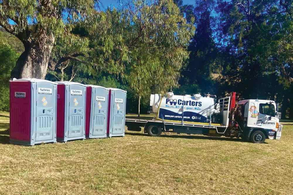 A row of portable toilets and a Poo Carters truck for hire for events and construction sites in the Yass Valley and Southern Tablelands-